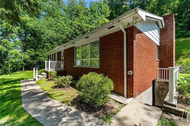 424 Porter Rd, Charleston, WV 25314 - view of side of home with brick siding, a chimney, and a lawn