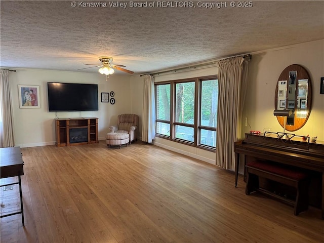 424 Porter Rd, Charleston, WV 25314 - living area with a textured ceiling, wood finished floors, a ceiling fan, and baseboards