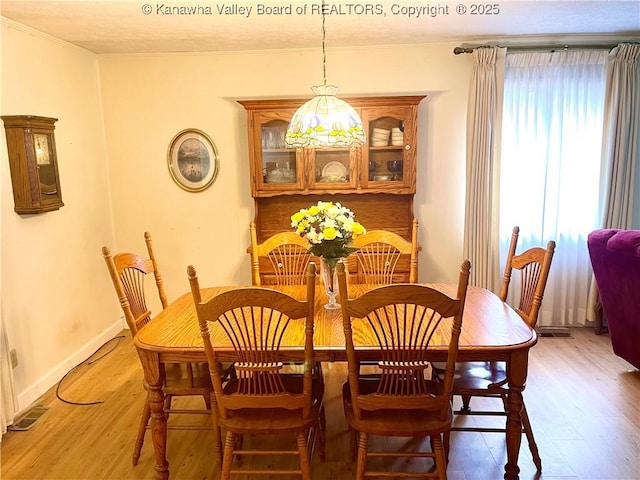 424 Porter Rd, Charleston, WV 25314 - dining room with light wood-type flooring, ornamental molding, and baseboards
