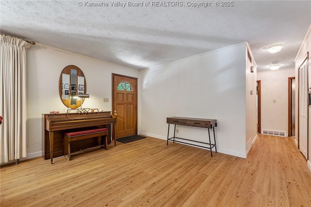 424 Porter Rd, Charleston, WV 25314 - foyer entrance with light wood finished floors, a textured ceiling, and baseboards