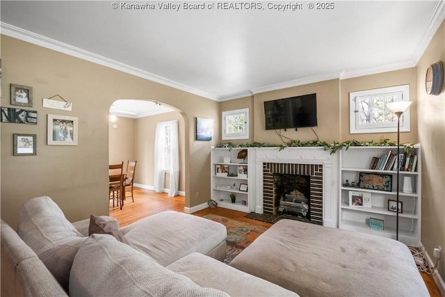 1539 Clark Rd, Charleston, WV 25314 - living area with arched walkways, wood finished floors, crown molding, baseboards, and a fireplace