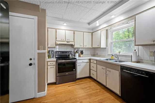 1539 Clark Rd, Charleston, WV 25314 - kitchen with black dishwasher, stainless steel range with electric cooktop, under cabinet range hood, light countertops, and an ornate ceiling