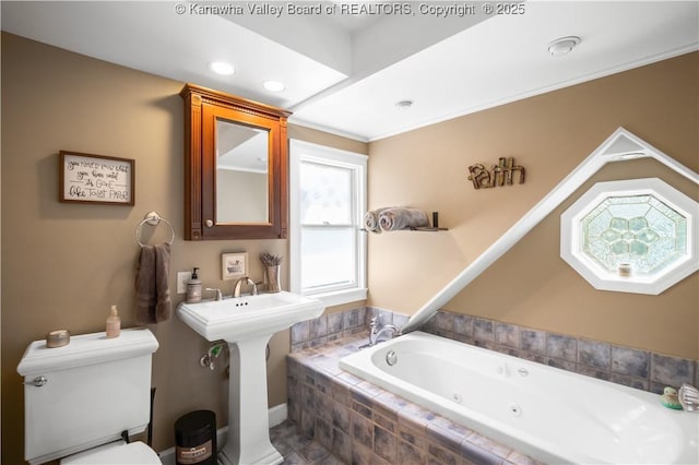1539 Clark Rd, Charleston, WV 25314 - bathroom featuring a jetted tub, toilet, and recessed lighting
