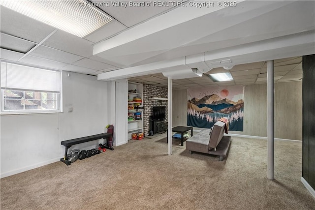 1539 Clark Rd, Charleston, WV 25314 - below grade area with carpet flooring, a paneled ceiling, baseboards, and a brick fireplace