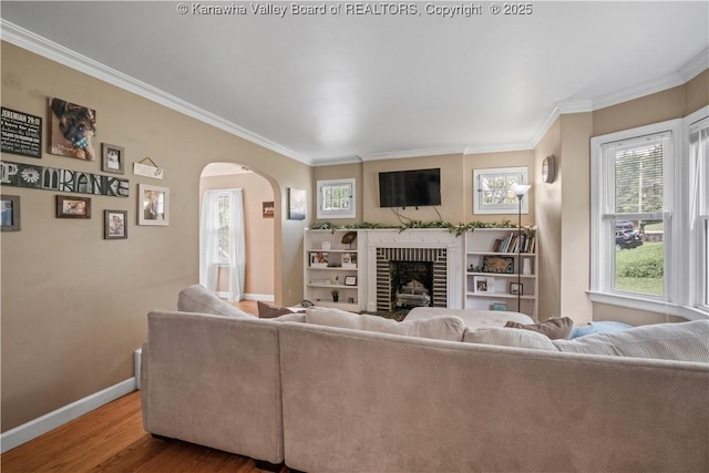 1539 Clark Rd, Charleston, WV 25314 - living room with baseboards, arched walkways, wood finished floors, crown molding, and a fireplace