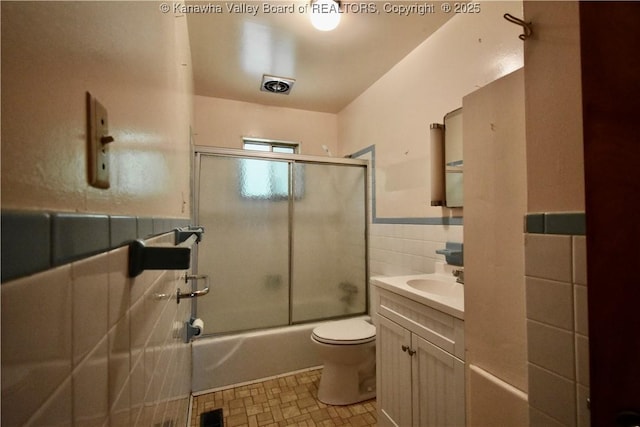 6 Coast Run Rd, Sandyville, WV 25275 - full bathroom featuring toilet, vanity, enclosed tub / shower combo, tile walls, and wainscoting