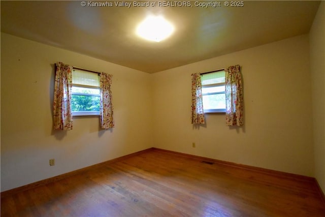 6 Coast Run Rd, Sandyville, WV 25275 - unfurnished room with healthy amount of natural light, wood finished floors, and baseboards