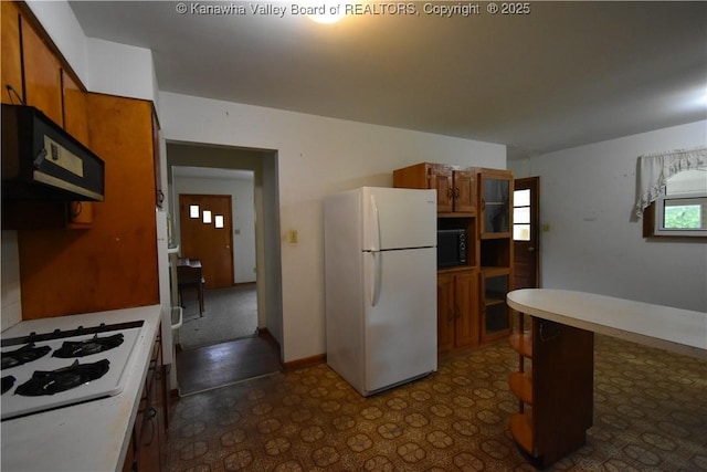 6 Coast Run Rd, Sandyville, WV 25275 - kitchen featuring white appliances, brown cabinets, light countertops, and dark floors