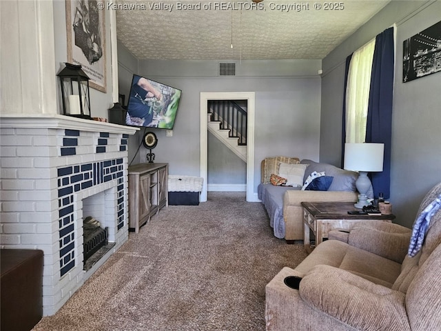 160 Davis St, Huntington, WV 25705 - carpeted living room featuring stairway, a brick fireplace, baseboards, and a textured ceiling