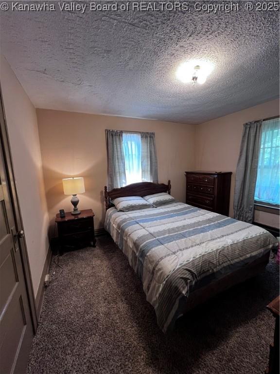 160 Davis St, Huntington, WV 25705 - carpeted bedroom featuring a textured ceiling and baseboards