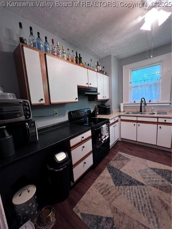 160 Davis St, Huntington, WV 25705 - kitchen featuring black range with electric cooktop, a sink, dark wood-style flooring, white cabinets, and a textured ceiling
