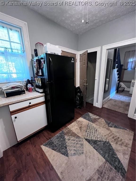 160 Davis St, Huntington, WV 25705 - kitchen with freestanding refrigerator, dark wood-type flooring, a textured ceiling, light countertops, and white cabinets