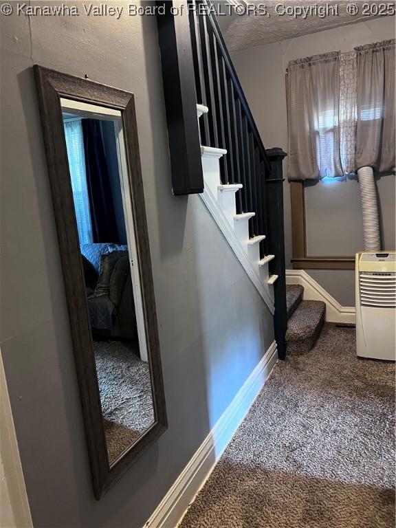 160 Davis St, Huntington, WV 25705 - staircase featuring carpet, baseboards, and a textured ceiling