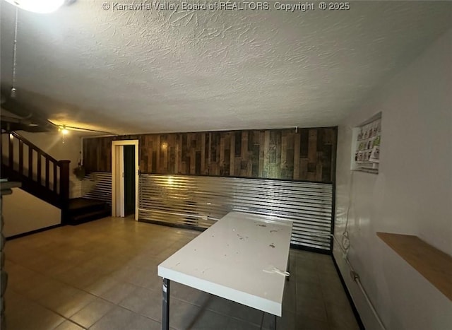 726 Amity Dr, Charleston, WV 25302 - tiled empty room featuring stairway and a textured ceiling