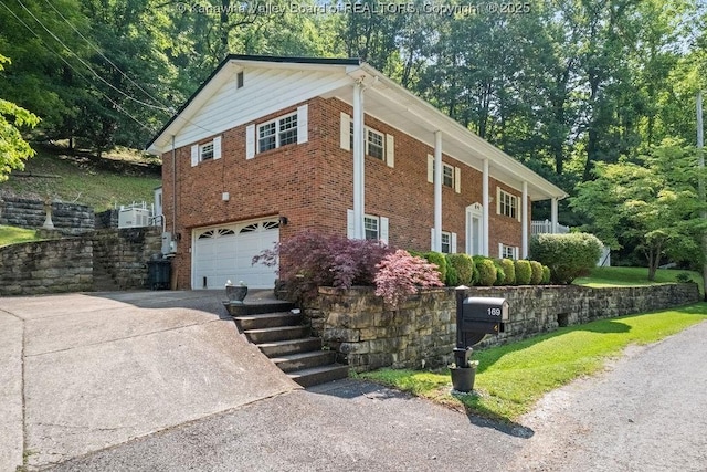 169 Burning Springs Dr, Belle, WV 25015 - view of property exterior featuring driveway, an attached garage, and brick siding