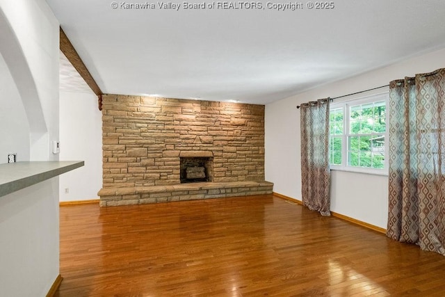 169 Burning Springs Dr, Belle, WV 25015 - unfurnished living room featuring wood finished floors, baseboards, and a stone fireplace