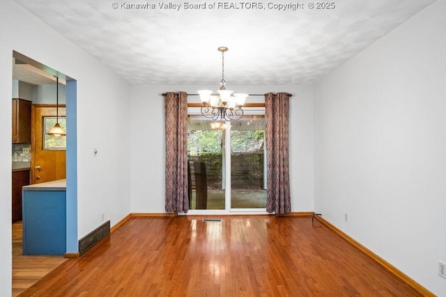169 Burning Springs Dr, Belle, WV 25015 - empty room featuring a chandelier, wood finished floors, and baseboards
