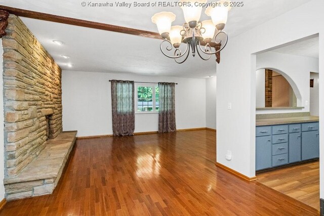 169 Burning Springs Dr, Belle, WV 25015 - unfurnished living room featuring a chandelier, wood finished floors, and baseboards