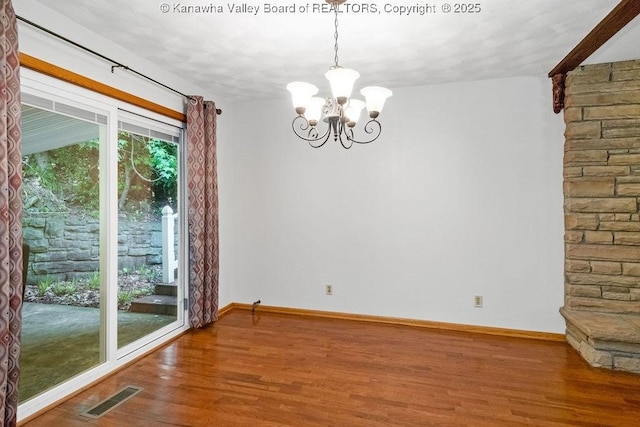 169 Burning Springs Dr, Belle, WV 25015 - unfurnished dining area featuring wood finished floors, a chandelier, and baseboards