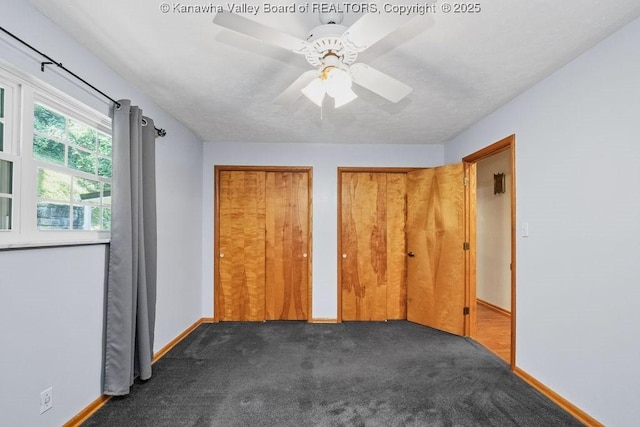 169 Burning Springs Dr, Belle, WV 25015 - unfurnished bedroom with multiple closets, dark carpet, baseboards, and ceiling fan