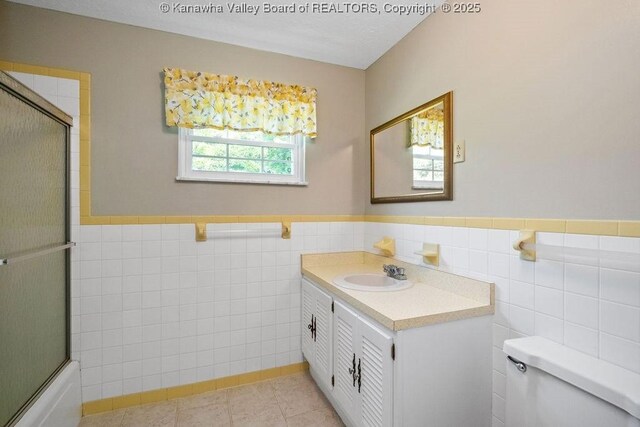 169 Burning Springs Dr, Belle, WV 25015 - full bathroom with tile walls, toilet, vanity, wainscoting, and tile patterned flooring
