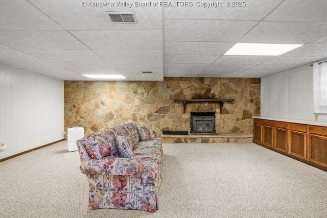 169 Burning Springs Dr, Belle, WV 25015 - living area with carpet floors, a wood stove, a drop ceiling, and baseboards