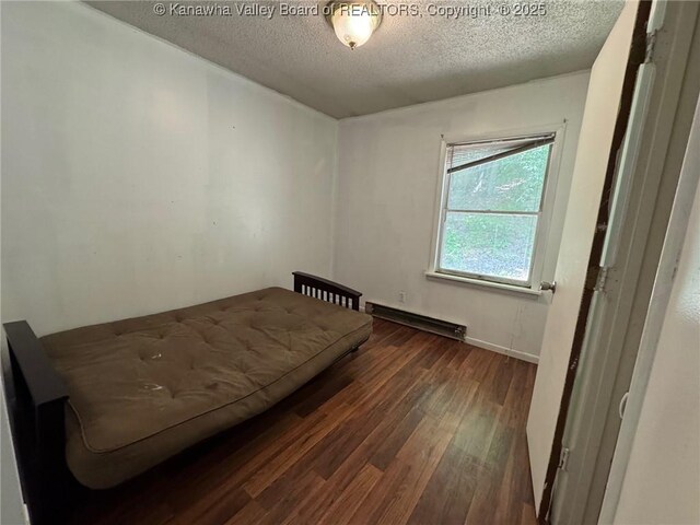 2608 Procious Maysel Rd, Wv, WV 25133 - bedroom featuring baseboard heating, wood finished floors, and a textured ceiling