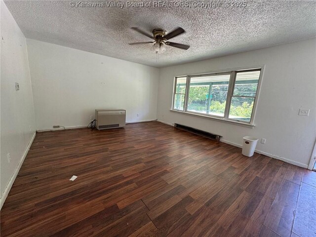 2608 Procious Maysel Rd, Wv, WV 25133 - unfurnished room featuring baseboard heating, wood finished floors, a ceiling fan, a textured ceiling, and baseboards