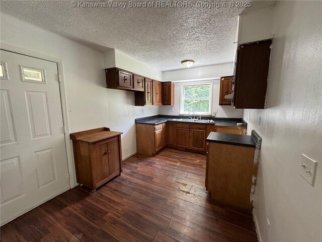2608 Procious Maysel Rd, Wv, WV 25133 - kitchen with dark wood-style floors, a sink, a textured ceiling, and dark countertops