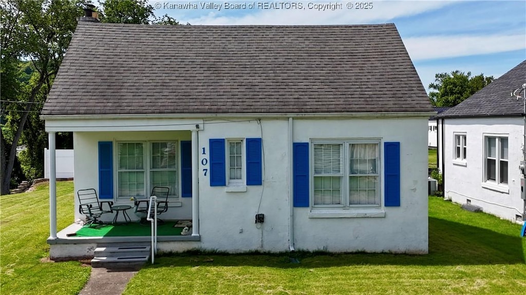 107 21st St, Dunbar, WV 25064 - view of front of property with covered porch, roof with shingles, a front lawn, and stucco siding
