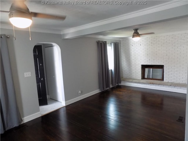 1004 E Riverview Dr, Belle, WV 25015 - unfurnished living room featuring ceiling fan, arched walkways, hardwood / wood-style floors, crown molding, and a brick fireplace