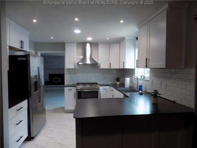 1004 E Riverview Dr, Belle, WV 25015 - kitchen featuring wall chimney range hood, stainless steel appliances, dark countertops, light marble finish flooring, and a peninsula