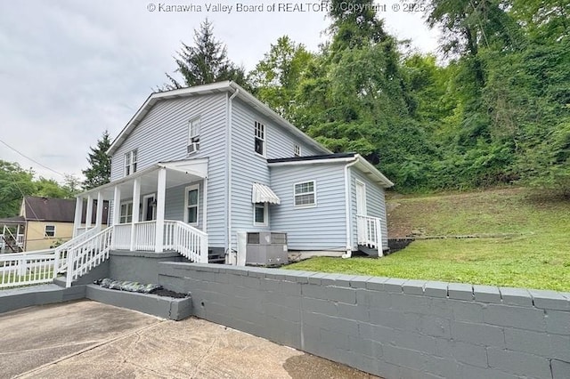547 Garrison Ave, Charleston, WV 25302 - view of side of home featuring covered porch, a yard, and central air condition unit
