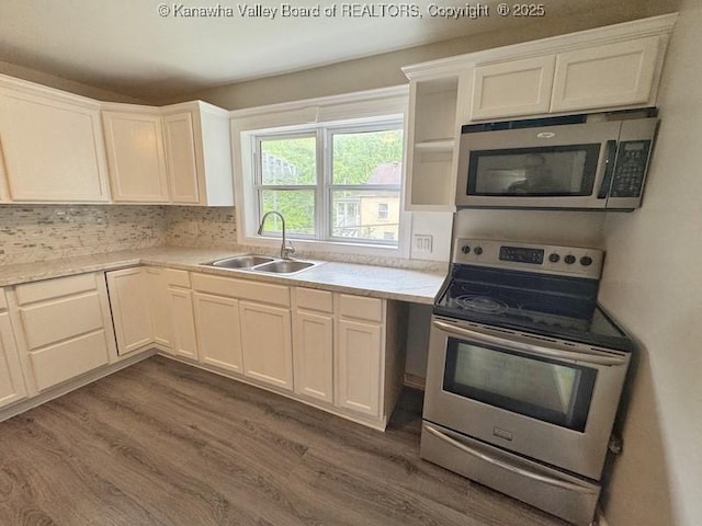 547 Garrison Ave, Charleston, WV 25302 - kitchen with stainless steel appliances, a sink, dark wood-style flooring, and light countertops
