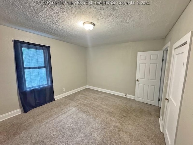 547 Garrison Ave, Charleston, WV 25302 - unfurnished bedroom with carpet, a textured ceiling, and baseboards