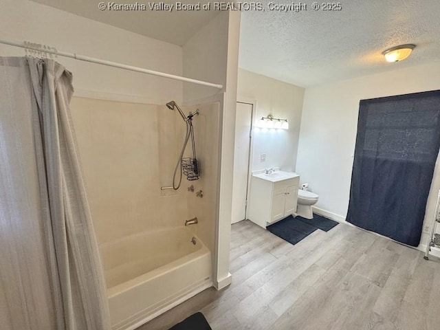 547 Garrison Ave, Charleston, WV 25302 - full bathroom with shower / bathtub combination with curtain, vanity, wood finished floors, a textured ceiling, and toilet