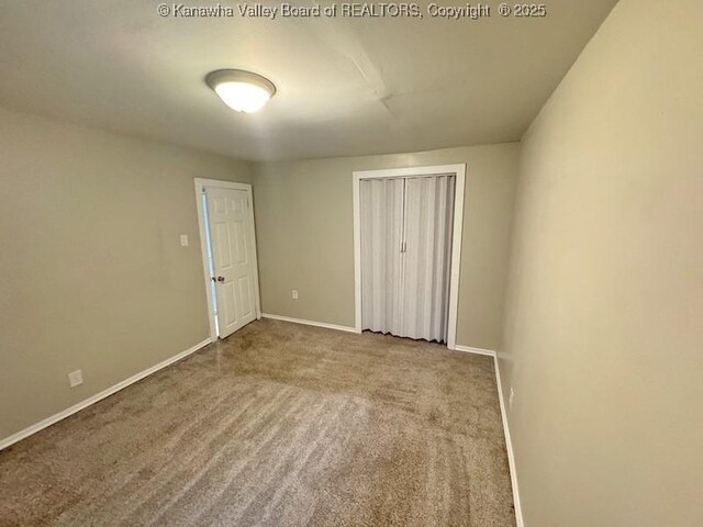 547 Garrison Ave, Charleston, WV 25302 - unfurnished bedroom with a closet, baseboards, and carpet flooring