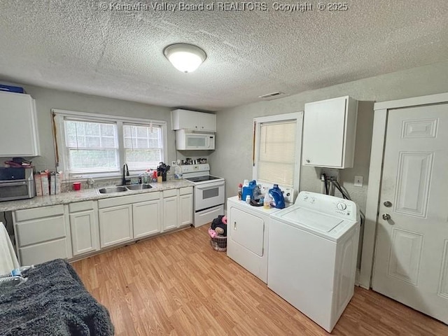 547 Garrison Ave, Charleston, WV 25302 - kitchen with white appliances, a sink, washer and clothes dryer, light wood-style flooring, and white cabinets