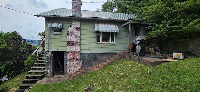 1214 Upper Vine St, Charleston, WV 25302 - back of house featuring stairway, metal roof, a chimney, and a lawn