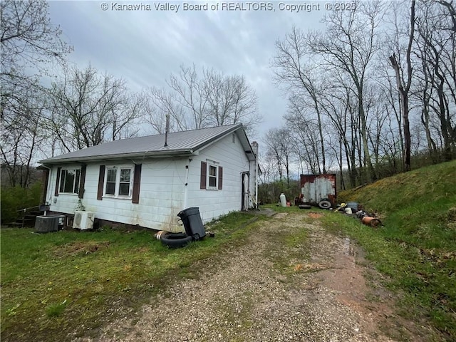 630 Melody Ln, Charleston, WV 25313 - view of property exterior featuring driveway, metal roof, and central AC