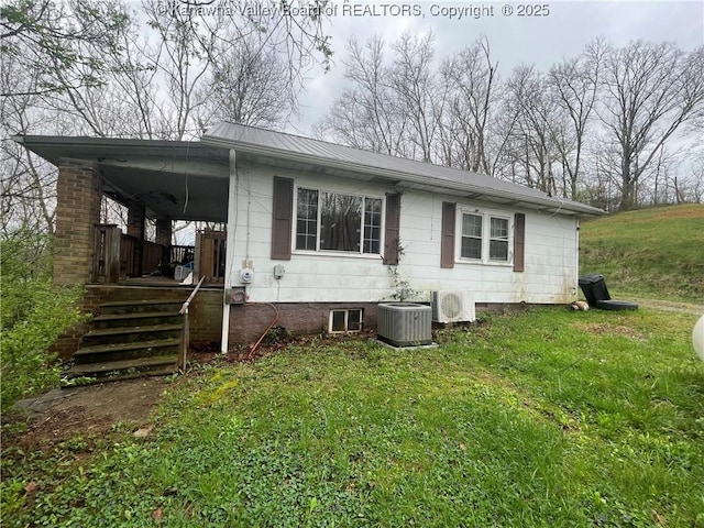 630 Melody Ln, Charleston, WV 25313 - view of front of home with cooling unit, a front lawn, metal roof, crawl space, and a porch