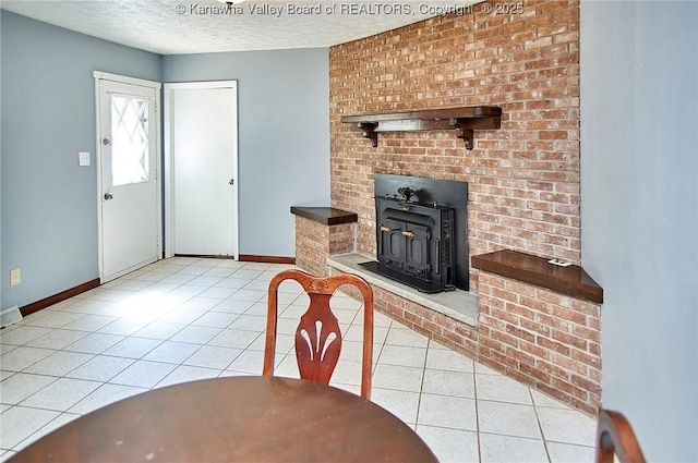124 Morningside Dr, Elkview, WV 25071 - foyer with tile patterned flooring, a wood stove, and a textured ceiling