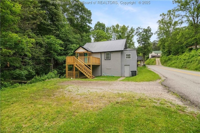 3742 Greenview Rd, South Charleston, WV 25309 - rear view of house featuring stairs, stucco siding, a yard, a wooden deck, and a metal roof