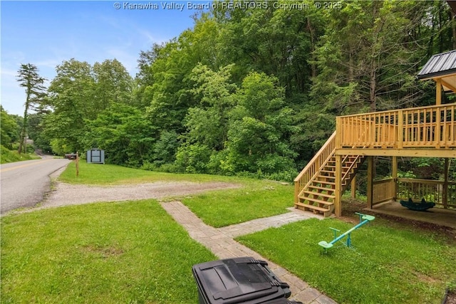3742 Greenview Rd, South Charleston, WV 25309 - view of grassy yard featuring stairway, a wooden deck, and a wooded view