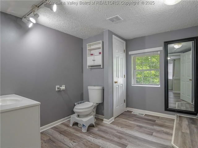 3742 Greenview Rd, South Charleston, WV 25309 - bathroom featuring wood finished floors, vanity, and a textured ceiling