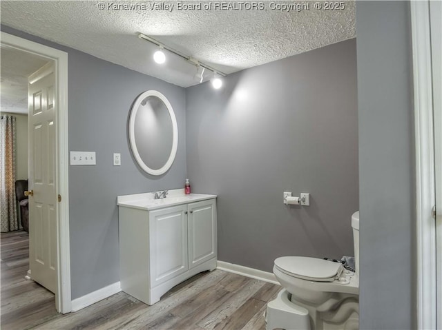 3742 Greenview Rd, South Charleston, WV 25309 - half bathroom with a textured ceiling, wood finished floors, vanity, and rail lighting