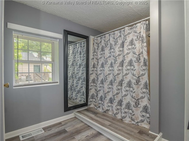 3742 Greenview Rd, South Charleston, WV 25309 - bathroom with a textured ceiling, wood finished floors, and curtained shower
