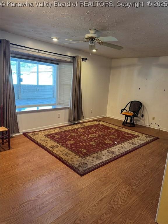 194 Shawnee Ests, Winfield, WV 25213 - living room featuring wood finished floors, a textured ceiling, and ceiling fan