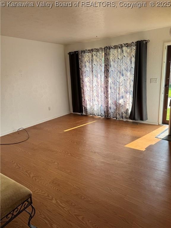 194 Shawnee Ests, Winfield, WV 25213 - empty room with wood finished floors and baseboards