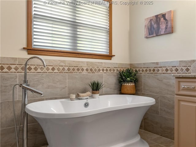 53 Wildrose Ln, Scott Depot, WV 25560 - full bath featuring tile walls, a soaking tub, and a wainscoted wall